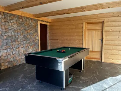 a pool table in a room with a stone wall at Noclegi Gal in Odrowąż