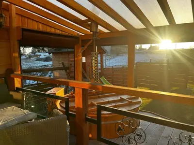 a screened in porch with the sun shining through the roof at Noclegi Gal in Odrowąż