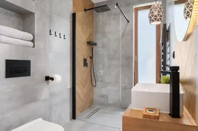 a bathroom with a shower and a white sink at Przy Szlaku in Zawoja