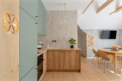 a kitchen with a table and a dining room at Przy Szlaku in Zawoja