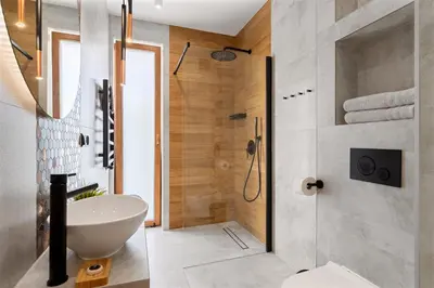 a bathroom with a white sink and a shower at Przy Szlaku in Zawoja