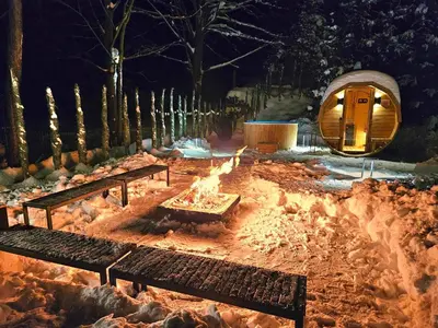 a fire pit in a park at night with benches at Przy Szlaku in Zawoja