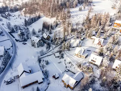 an aerial view of a village covered in snow at Przy Szlaku in Zawoja