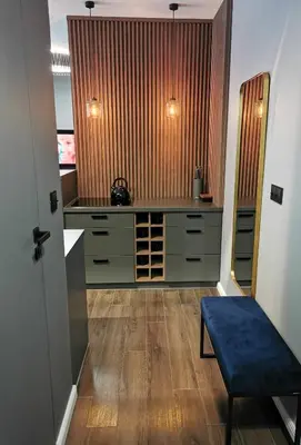 a kitchen with green cabinets and a blue bench at Apartament Raciborska 1 in Kraków