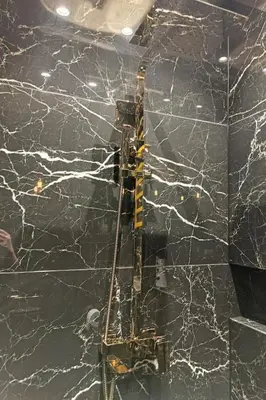 a yellow crane on a black marble wall at Apartament Raciborska 1 in Kraków