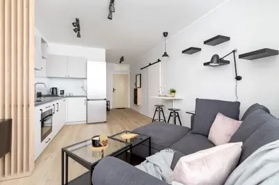 a living room with a couch and a table at Świtezianki Luxurious Apartments with Parking by Renters Prestige in Kraków