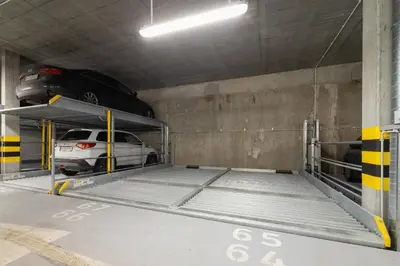 a parking garage with a car on a ramp at Świtezianki Luxurious Apartments with Parking by Renters Prestige in Kraków