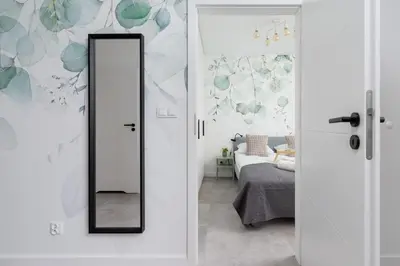a mirror in a room with a bed at Świtezianki Luxurious Apartments with Parking by Renters Prestige in Kraków