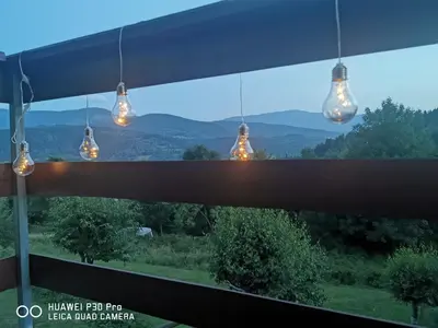 a view of the mountains from a house with lights at Domek na Niedźwiedziarce in Zawoja