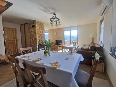 a living room with a table and a couch at Domek na Niedźwiedziarce in Zawoja