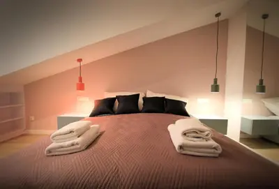 a bedroom with a bed with two towels on it at Wawel View Apartment in Kraków