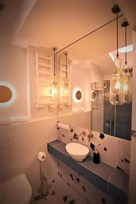 a bathroom with a sink and a mirror at Wawel View Apartment in Kraków