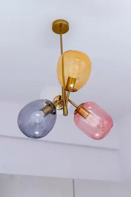 a chandelier with two lights hanging from a ceiling at Wawel View Apartment in Kraków