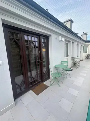 a patio with a glass door and a table and chairs at Wawel View Apartment in Kraków