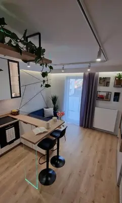 a living room with a table and two chairs at Magic House Apartament Proszowska 58 in Bochnia