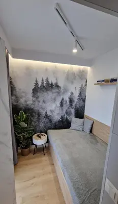 a bedroom with a bed and a painting on the wall at Magic House Apartament Proszowska 58 in Bochnia