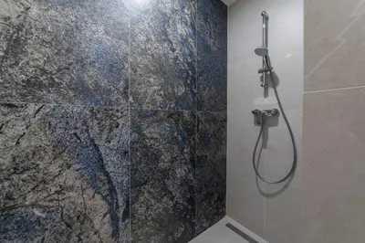 a bathroom with a shower with a glass door at MILU Apartments Sebastiana in Kraków