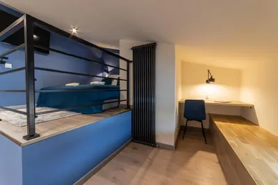 a bedroom with a bunk bed and a desk at MILU Apartments Sebastiana in Kraków