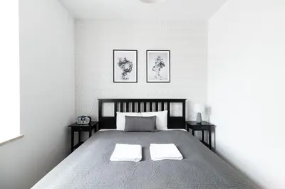 a bedroom with a large bed with two night stands at NEO UNIQUE & BRIGHT Apartments, FREE PARKING, 15min Old Town & Kazimierz - by Homelike Krakow in Kraków