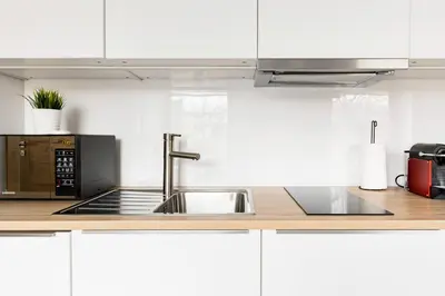 a kitchen with a sink and a microwave at NEO UNIQUE & BRIGHT Apartments, FREE PARKING, 15min Old Town & Kazimierz - by Homelike Krakow in Kraków