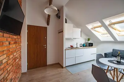a kitchen and dining room with a brick wall at NEO SKY Apartment, FREE PARKING, 15 min walk Old Town&Kazimierz - by Homelike Krakow in Kraków