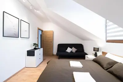 a living room with a couch and a chair at NEO SKY Apartment, FREE PARKING, 15 min walk Old Town&Kazimierz - by Homelike Krakow in Kraków