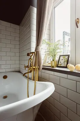 a white bathroom with a tub and a window at Glamour Old Town Blich Kraków in Kraków