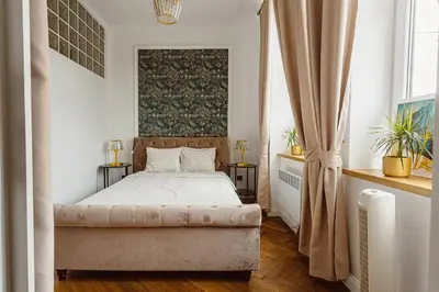 a bedroom with a bed and a large window at Glamour Old Town Blich Kraków in Kraków