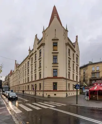 a large building on a street with cars parked in front at Glamour Old Town Blich Kraków in Kraków