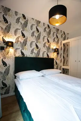 a bedroom with a bed and a wall with butterflies at Krakow Centrum Sunny Apartment Lwowska 10 in Kraków