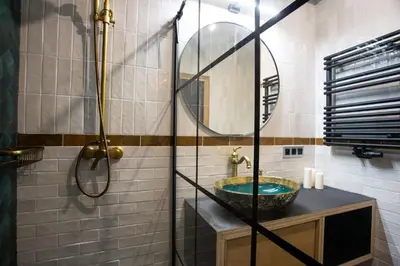 a bathroom with a sink and a mirror at Krakow Centrum Sunny Apartment Lwowska 10 in Kraków