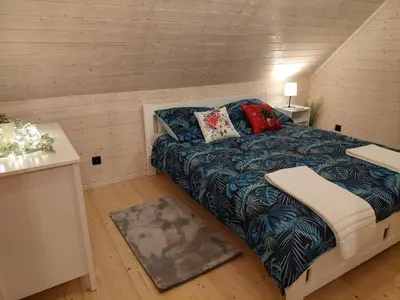 a small bedroom with a bed with pillows on it at Sielski Zakątek Dąbrówka Domki in Dąbrówka