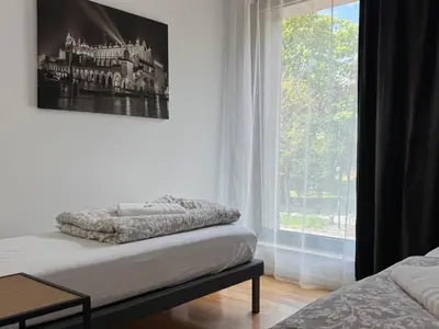 a room with a bed and a window with a picture at AMBER APARTAMENt 127 in Kraków
