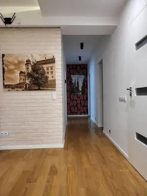 an empty room with a brick wall and a door at AMBER APARTAMENt 127 in Kraków