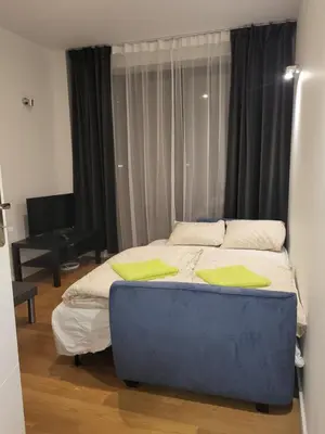 a bedroom with a bed with two yellow pillows on it at AMBER APARTAMENt 127 in Kraków