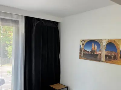 a room with a window with a picture of a city at AMBER APARTAMENt 127 in Kraków