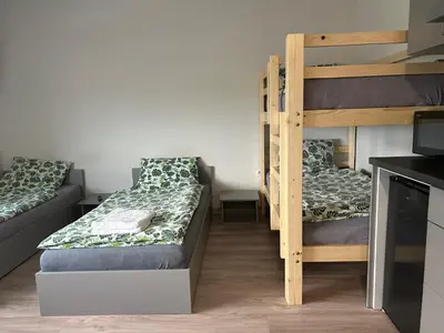 a room with two bunk beds and a kitchen at Noclegi URAN in Sufczyn