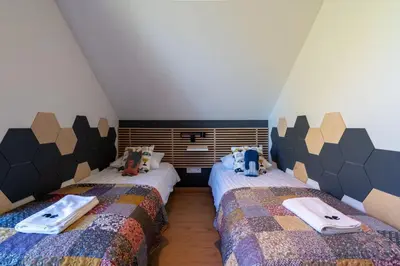 a bedroom with two twin beds with towels on them at Drwalówka - Domek 