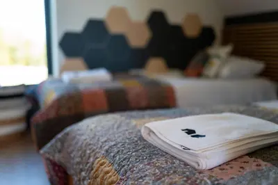 a close up of a pillow on the edge of a bed at Drwalówka - Domek 