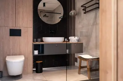 a bathroom with a sink and a toilet at Drwalówka - Domek 