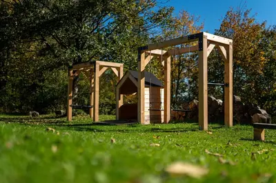a small playground in a grassy field at Drwalówka - Domek 