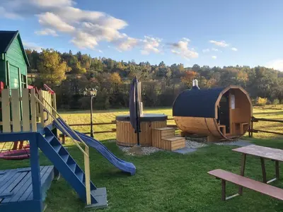a playground with a slide and a igloo at Domek pod Hajdówką in Jordanów