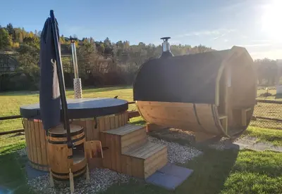 a small wooden boat with a table and a umbrella at Domek pod Hajdówką in Jordanów