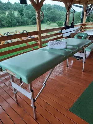 a group of benches sitting on a deck at Domek pod Hajdówką in Jordanów