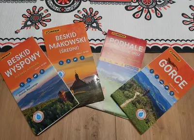 four books sitting on top of a table at Domek pod Hajdówką in Jordanów
