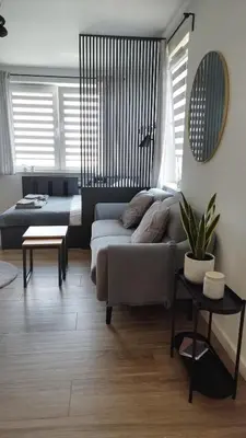 a living room with a couch and a table at Apartment Between in Kraków