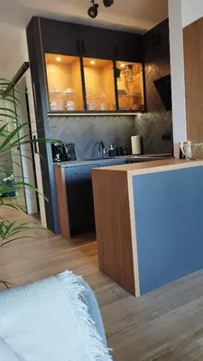 a kitchen with a sink and a counter top at Apartment Between in Kraków