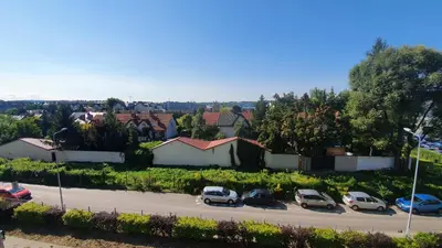 a group of cars parked in a parking lot at Apartment Between in Kraków