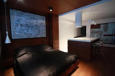 a bedroom with a bed and a counter and a desk at Modern & Resto Apartments in Kraków