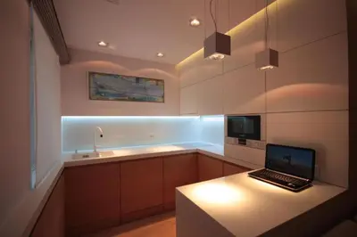a kitchen with a laptop computer on a counter at Modern & Resto Apartments in Kraków